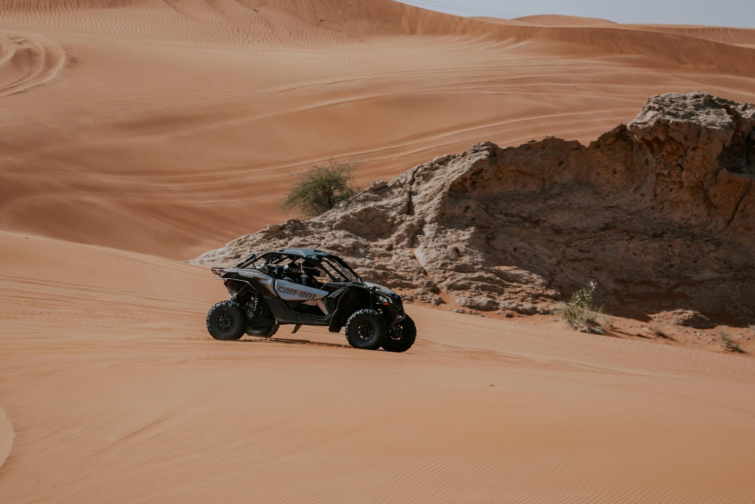 Explore thrill and adventure riding an ATV across picturesque desert dunes.